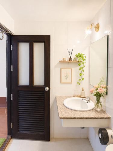 a bathroom with a sink and a mirror at Baan Lanna ChiangRai in Chiang Rai