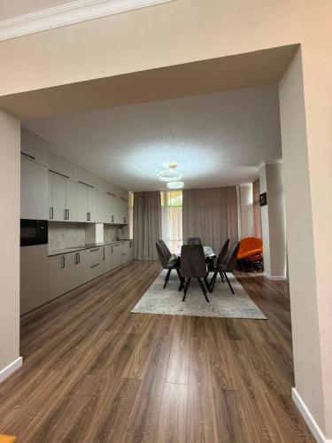 an empty living room with a table and chairs at Карвен коттедж in Bulan Sogottuu