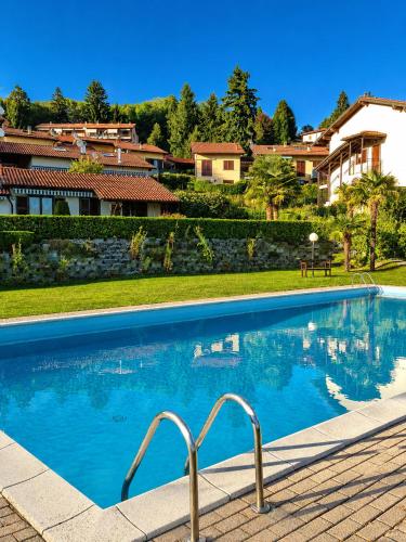 a swimming pool in front of a house at Residenza Paradiso in Agra