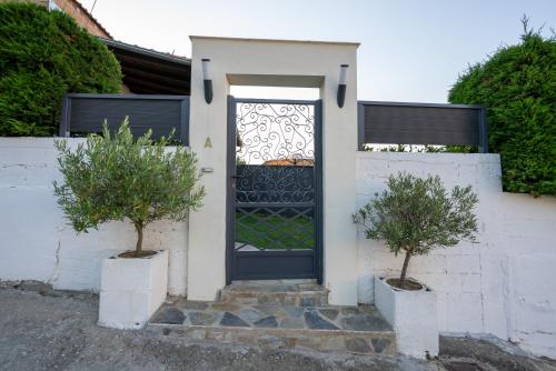 a front door of a white house with two trees at Catherine's Seaside House A in Stomio