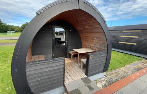 a dog house with a table and a bench in it at Beautiful Home In Skjern in Skjern