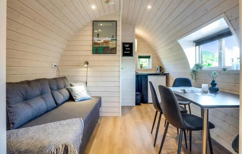 a living room with a couch and a table with chairs at Beautiful Home In Skjern in Skjern