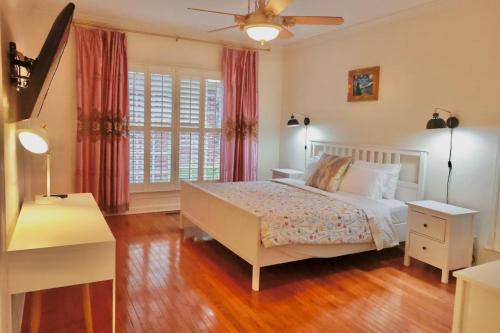a bedroom with a bed and a large window at Elegant Suite King Bed, Queen Sofa, Fast WiFi in Fayetteville