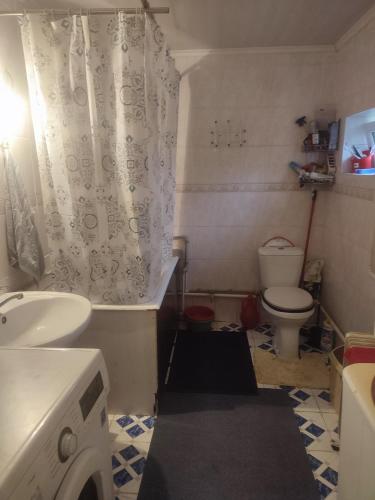 a small bathroom with a sink and a toilet at Guesthouse Arnas in Bokonbayevo