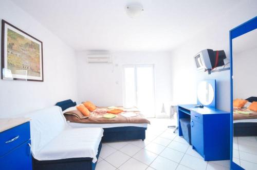 a room with two beds and a desk with a mirror at Stojko Rafailovici in Rafailovici