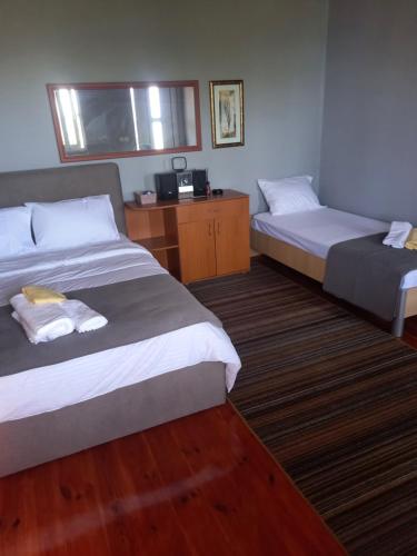 a hotel room with two beds and a television at Sonja Sea View House in Zagrađe