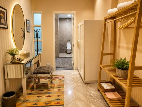 a hallway with a staircase and a bathroom with a mirror at Rose Amer in Jaipur