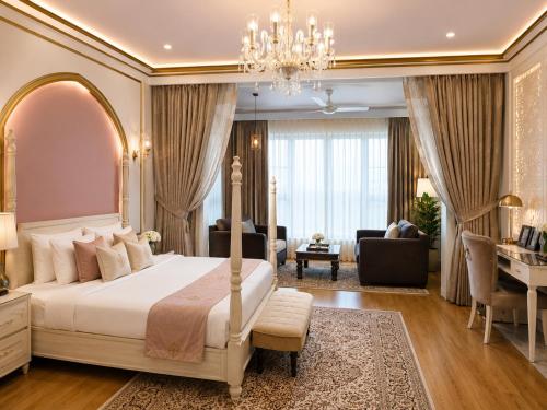 a bedroom with a bed and a living room at Rose Amer in Jaipur
