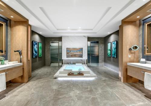 a bathroom with a bath tub and a shower at Regnum Carya in Belek