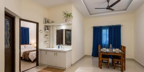 a bathroom with a sink and a bed and a mirror at Urban Escape in Cochin