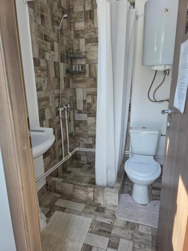 a bathroom with a toilet and a sink at Holiday Village in Eforie Nord