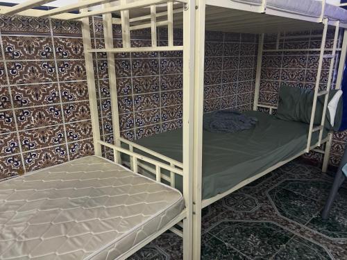 a couple of bunk beds in a room at Turkish Muscat hostel in Muscat