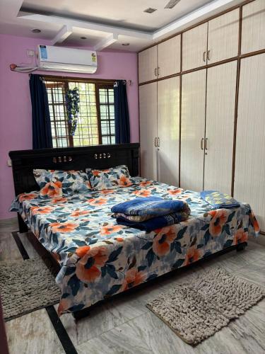a bedroom with a bed with pillows on it at Lara Homestay duplex 3bhk in Secunderabad