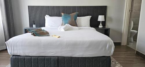 a large white bed in a hotel room at Sonrise Stays in Gaborone