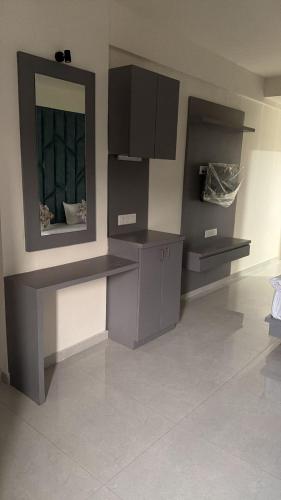 a room with a counter and a mirror on the wall at Hotel Runway in Vadodara
