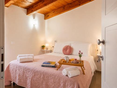 a bedroom with a bed with a tray of food on it at Il Sogno di Ulisse in Le Castella