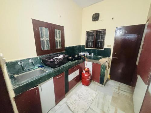 a kitchen with a sink and a fire hydrant at Lara Homestay 2bhk in Secunderabad
