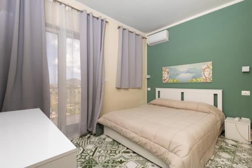 a bedroom with a bed and a window at villa oltremare resort in Bagheria