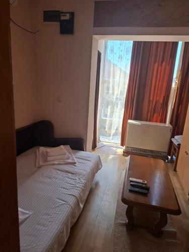 a bedroom with a bed and a laptop on a table at Apartmani Lazić No 4 in Gracanica