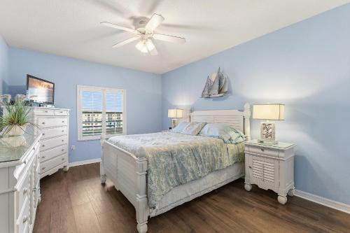 a bedroom with a bed and a ceiling fan at Oceanwalk 9-604 in New Smyrna Beach