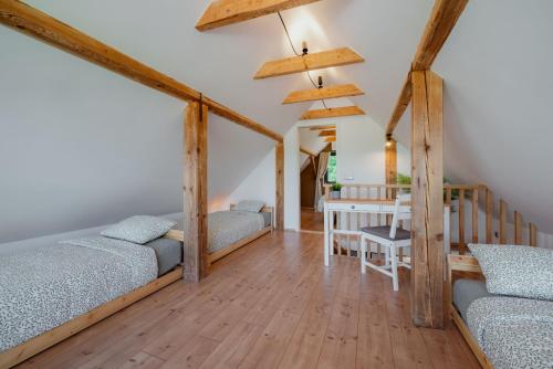 a room with two beds and a dining table at Hiša pri Lipi in Pristava pri Mestinju