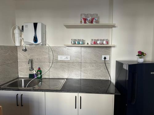 a kitchen with a sink and a counter top at North scape 104 in Bangalore