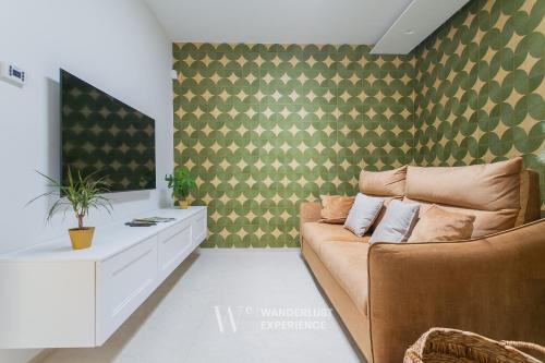 a living room with a couch and a tv at Wanderlust Experience Villa Milly in Giovinazzo