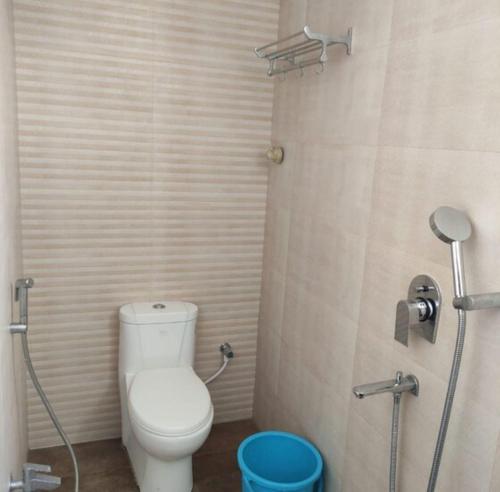 a small bathroom with a toilet and a shower at Eennra Kaansabbati in Medinīpur