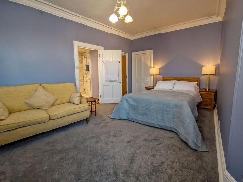 a bedroom with a bed and a couch at Tower Hotel in Oxton