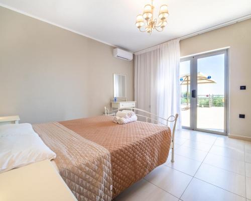 a bedroom with a bed and a sliding glass door at Villa Joya by Villa Select in Skala