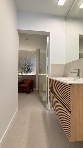 a bathroom with a sink and a mirror at La Paratá Suites Mojácar in Mojácar