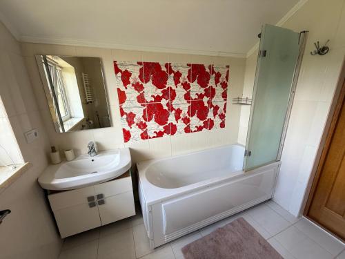 a bathroom with a sink and a tub and a toilet at БУДИНОК сімейних ПРИГОД in Vodniki