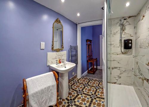 a bathroom with a sink and a shower at Tower Hotel in Oxton