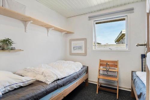 a bedroom with a bed and a window at FY222-Otterup-Klovervaenget-13 in Otterup