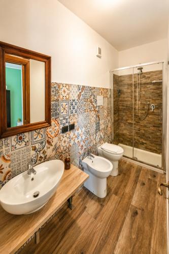a bathroom with a sink and a toilet and a shower at La quercia di Massena in Lauria Inferiore