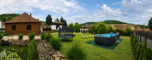 a yard with a playground and a house at Mátrai pincés udvar in Mátramindszent