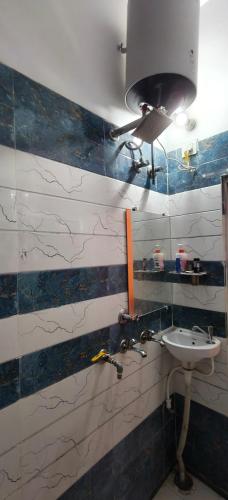 a bathroom with a sink and a mirror at Sri Narayan Home Stay in Ayodhya