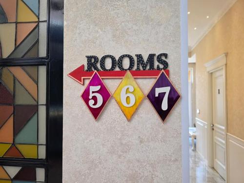 a wall with rooms signs on a wall at Arts Hotel by Square in Tbilisi City