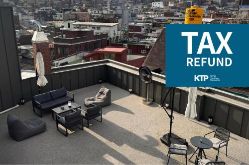 a sign on a roof with a view of a city at Original Backpackers in Seoul