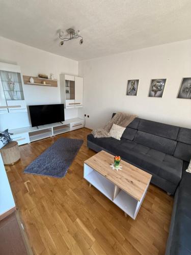 a living room with a couch and a table at Апартамент “Djanina 2” in Sandanski