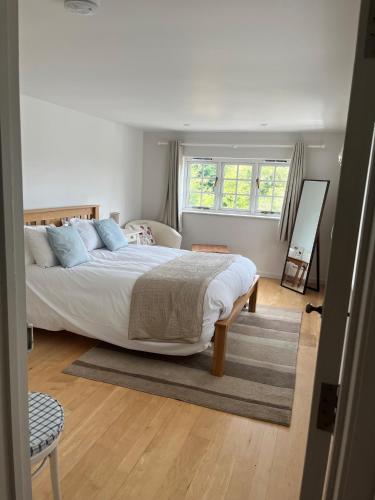 a bedroom with a large bed and a window at Gorse cottage in Newton Abbot