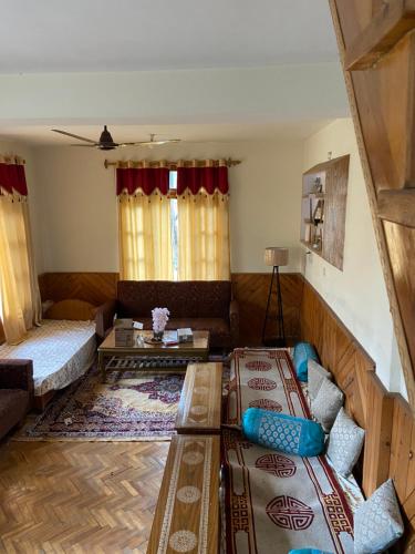 a living room with a couch and a table at Walking Trails Homestay in Baragrān