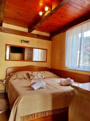a bedroom with a bed in a room with a window at Vila s bazenom Mavrinac in Nerezine