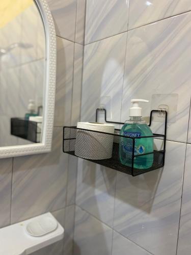 a bathroom with a soap dispenser on a wall at Le Poulagou in Saint-Louis