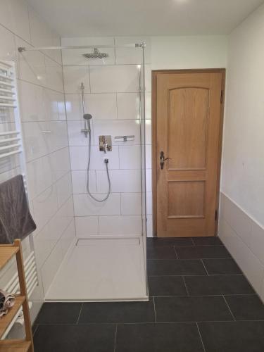 a bathroom with a shower with a glass door at Bio Berghof Langerlehen in Berchtesgaden