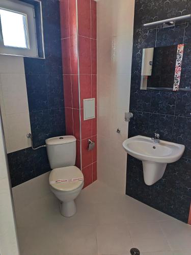 a bathroom with a toilet and a sink at Fits Guest House in Primorsko