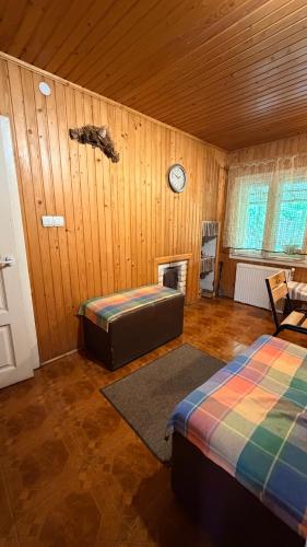 a room with two beds and a clock on the wall at Stara Praha Loft Rooms in Uzhhorod