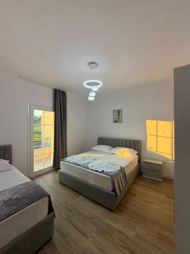 a bedroom with two beds and a window at Arkej Pool Aparthotel in Golem