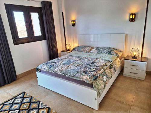 a bedroom with a bed and two night stands at CASA LOKO Guest House in Luxor