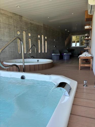 a large bathroom with a bath tub and a tub at ili ili Hotel Boutique in Mar del Plata